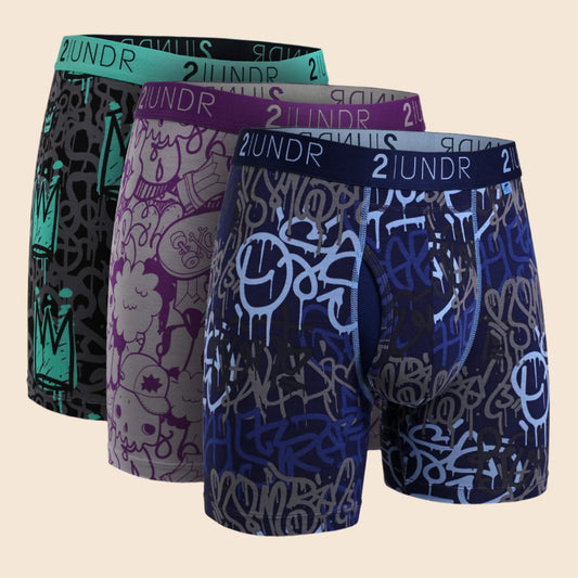 Four pairs of men's underwear with different patterns and colors on a white background.